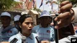 Cambodian protester Tep Vanny, center, talks with journalists after she and a group of others from Beung Kak lake submitted a petition to the National Assembly asking the government to return the title of their land, in Phnom Penh, Cambodia, Wednesday, May 2, 2012. (AP Photo/Heng Sinith)