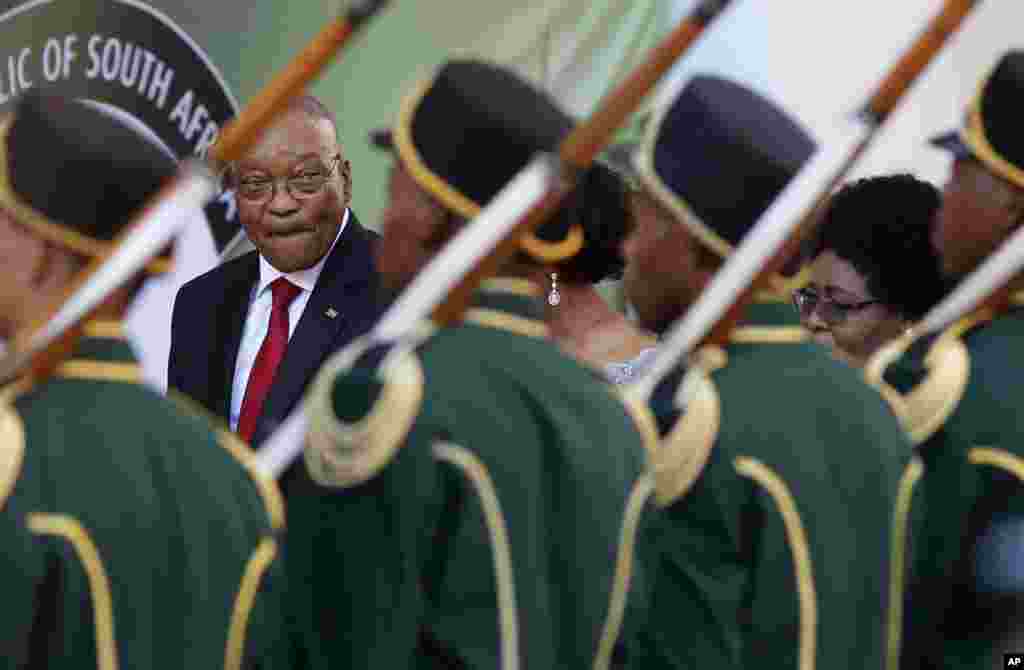 South African President Jacob Zuma, background left, reviews the guard of honor at Parliament in Cape Town, South Africa.