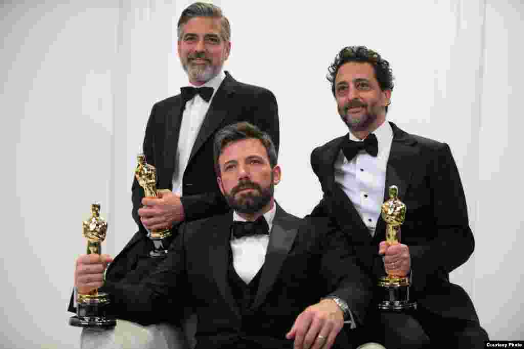 Producers George Cloney, Ben Affleck, and Grant Heslov pose backstage with their Oscars® for best motion picture of the year for “Argo”.(Photo: Matt Petit / ©A.M.P.A.S)