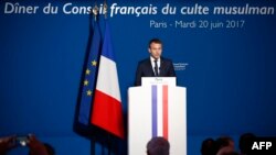 FILE - French President Emmanuel Macron delivers a speech prior to attend a dinner organised by the French Council of the Muslim Faith (CFCM) to break the fast of Ramadan, in Paris, June 20, 2017. 