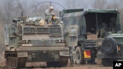 FILE - A U.S. Army soldier sits on an armored vehicle during an annual exercise in Yeoncheon, near the border with North Korea, March 7, 2016.