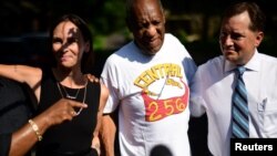 FILE - Bill Cosby is welcomed outside his home after Pennsylvania's highest court overturned his sexual assault conviction and ordered him released from prison immediately, in Elkins Park, Pennsylvania, June 30, 2021. 