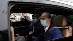Members of a World Health Organization team arrive at the Hubei Center for Disease Control and Prevention in Wuhan in central China's Hubei province Monday, Feb. 1, 2021. (AP Photo/Ng Han Guan)