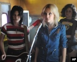 Joan Jett (Kristan Stewart), Cherie Currie (Dakota Fanning), and Robin (Alia Shawkat) practice in “The Runaways”