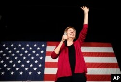 FILE - Sen. Elizabeth Warren, D-Mass, waves to the crowd during an organizing event in Des Moines, Iowa, Jan. 5, 2019.