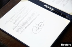 U.S. President Barack Obama's signature is seen on a set of executive orders that he signed prior to unveiling a series of proposals to counter gun violence, at the White House in Washington, January 16, 2013.
