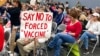 FILE - Audience members gather during a meeting of New Hampshire's Executive Council in Concord, N.H., Oct. 13, 2021. New Hampshire on Oct. 29 joined a lawsuit against the Biden administration seeking to block a COVID-19 vaccine mandate for federal contractors.