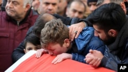 Family members and friends mourn as they attend funeral prayers for Ayhan Akin, one of the nightclub victims, in Istanbul, Jan. 1, 2017.