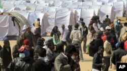Migrant workers, who used to work in Libya and fled the recent unrest in the country, are seen in a refugee camp at the Tunisia-Libyan border, in Ras Ajdir, Tunisia, March 9, 2011. (AP Image)