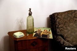 A Pernod opalex ashtray, a 1950's Gablonz Uranium Glass ring and a 1940's Uranium Glass soda siphon are seen in Wangen an der Aare, Switzerland, Jan. 23, 2018.