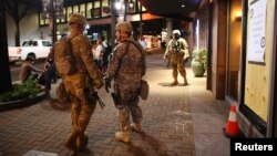 U.S. National Guard soldiers prepare for another night of protests over the police shooting of Keith Scott in Charlotte, North Carolina, Sept. 22, 2016.