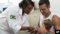 A nurse vaccinates a toddler against yellow fever at a public health clinic in Rio de Janeiro, Brazil, March 16, 2017. 
