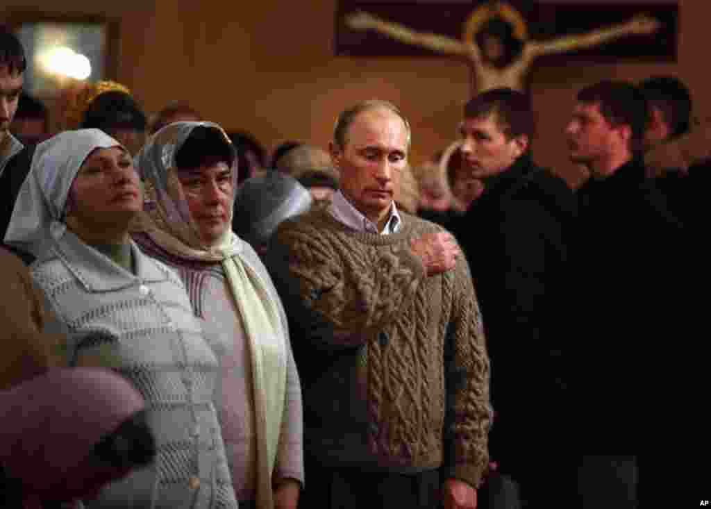 Jan. 7: Russian Prime Minister Vladimir Putin (C) crosses himself as he attends an Orthodox Christmas service in Turginovo village, about 160 km northwest of Moscow. Putin's parents were baptized in Turginovo village in 1911. (Alexander Zemlianichenko/Reu