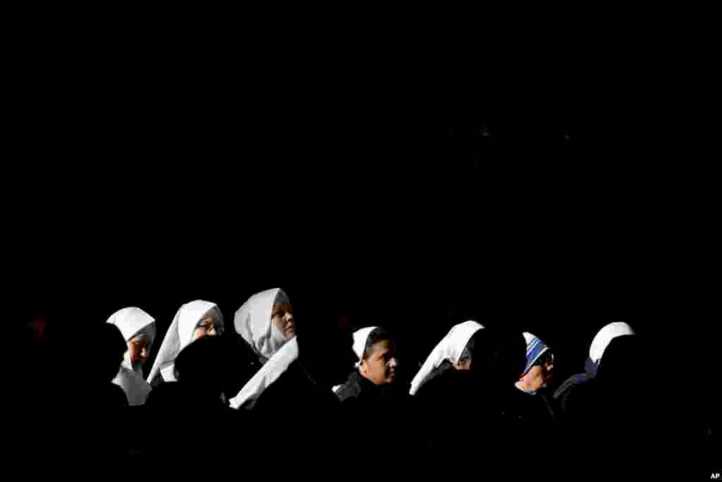 Nuns attend a mass celebrated by Pope Francis in St. Peter&#39;s Basilica, at the Vatican, to mark Epiphany. The Epiphany day is a joyous day for Catholics in which they recall the journey of the Three Kings, or Magi, to pay homage to baby Jesus.