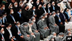 Nuns wearing FFP2 masks listen to Pope Francis during his weekly general audience in the Paul VI Hall, at the Vatican, Jan. 5, 2022.