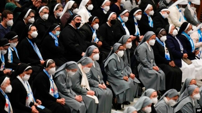 Nuns wearing FFP2 masks listen to Pope Francis during his weekly general audience in the Paul VI Hall, at the Vatican, Jan. 5, 2022.