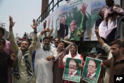 Supporters of Pakistani former prime minister Nawaz Sharif chant slogans in Lahore, Pakistan, July 13, 2018.