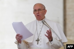 FILE - Pope Francis addresses the crowd during the Regina Coeli prayer at St. Peter's square at the Vatican, April 30, 2017.