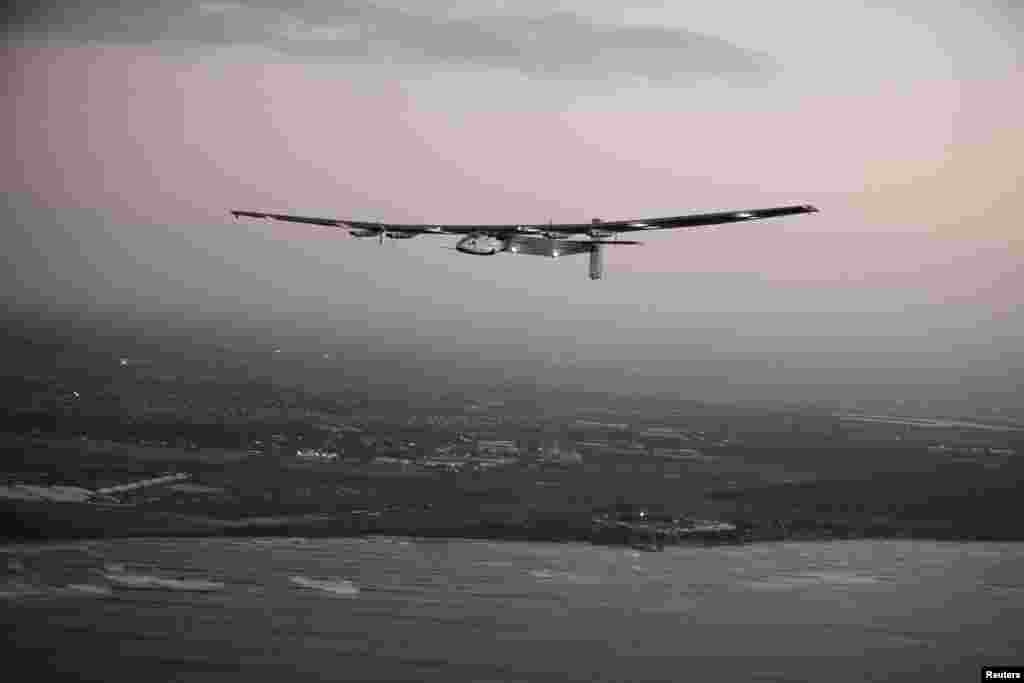 The Solar Impulse 2 airplane, flown by test pilot Markus Scherdel, flies off the coast of Oahu during a test flight from Kalaealoa Airfield in Kapolei, Hawaii.