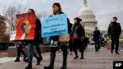 People march in support of the Deferred Action for Childhood Arrivals (DACA), and Temporary Protected Status (TPS), programs, Dec. 5, 2017, on Capitol Hill in Washington.