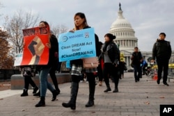 FILE - People march in support of the Deferred Action for Childhood Arrivals (DACA), and Temporary Protected Status (TPS), programs, Dec. 5, 2017, on Capitol Hill in Washington.