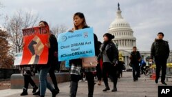 People march in support of the Deferred Action for Childhood Arrivals (DACA), and Temporary Protected Status (TPS), programs, Dec. 5, 2017, on Capitol Hill in Washington. 