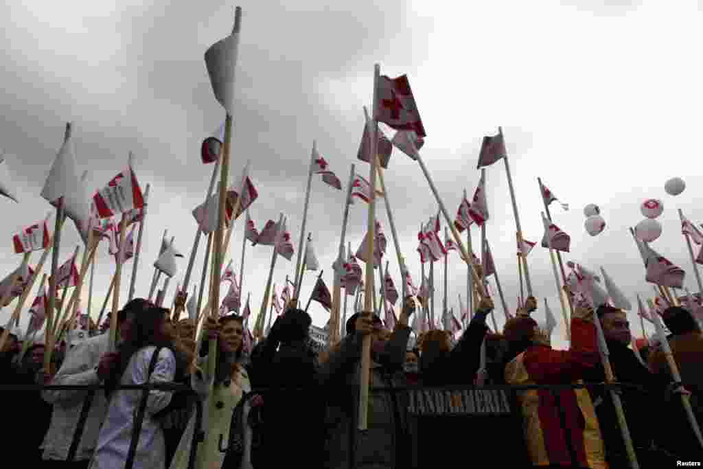 Doctors, nurses, medical students and teachers hold flags during a protest against low wages and poor working conditions in Romania's hospitals in Bucharest.