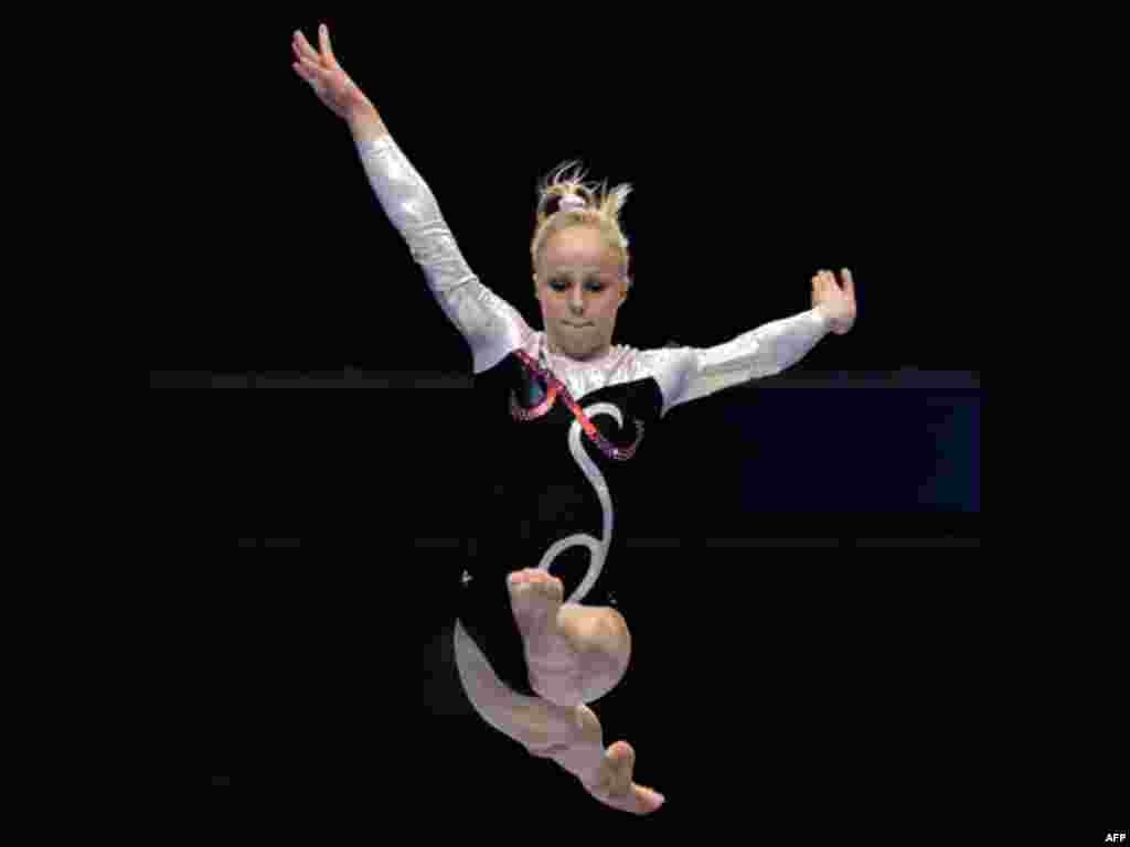 Sweden's Jonna Adlerteg performs on the balance beam during the women's qualifying of the Artistic Gymnastics World Championships in Tokyo, Japan, Friday, Oct. 7, 2011
