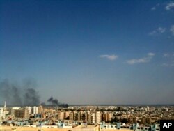 FILE - Smoke rises over the skyline in the Qaboun neighborhood of Damascus, Syria, July 19, 2012, during shelling by Syrian government forces.