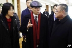 Wu Dawei, center, China's special representative for Korean Peninsula Affairs, is greeted by Pak Song Il, right, deputy director of the America department at the North Korean Foreign Ministry, upon arrival in Pyongyang, Feb. 2, 2016.