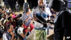 Tersangka pekerja ilegal sedang diperiksa oleh petugas imigrasi Malaysia saat pelaksanaan razia untuk menindak tegas imigran gelap di pinggiran Port Dickson, Negeri Sembilan, Malaysia, Selasa, 11 Juli 2017.