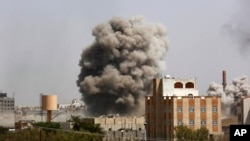Smoke rises after a Saudi-led airstrike hits an army academy in Sana'a, Yemen, Sunday, Sept. 20, 2015.