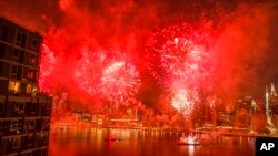 With the New York City skyline in the background, fireworks explode during an Independence Day show over the East River, Wednesday, July 4, 2018, in New York.