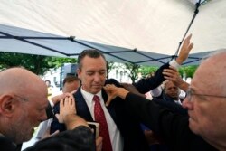 FILE - In this June 7, 2021 file photo, Tony Spell, pastor of the Life Tabernacle Church of Central City, La., prays with supporters outside the Fifth Circuit Court of Appeals in New Orleans.