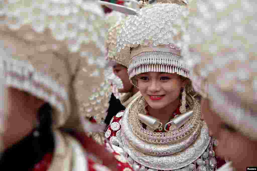 Ethnic Miao women wearing traditional costumes take part in a parade during the traditional Lusheng (reed-pipe wind instrument) festival in Gulong, Guizhou province, China, Nov. 15, 2017.