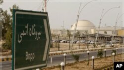 A sign reading "Atomic Power plant" points the way to the nuclear power plant in Bushehr, Iran, Feb. 25, 2009.