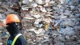 FILE - A container is filled with plastic waste from Australia, in Port Klang, Malaysia, May 28, 2019.