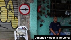 First aider Wellington Carvalho sits next to medical equipment in the city's biggest slum Paraisopolis after residents hired a 24-hour private medical service, in Sao Paulo, Brazil March 30, 2020.