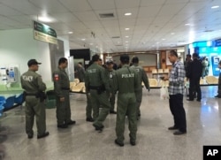 Police investigators work at the lobby of Phramongkutklao Hospital, a military-owned hospital that is also open to civilians, in Bangkok after a bomb wounded more than 20 people, May 22, 2017.