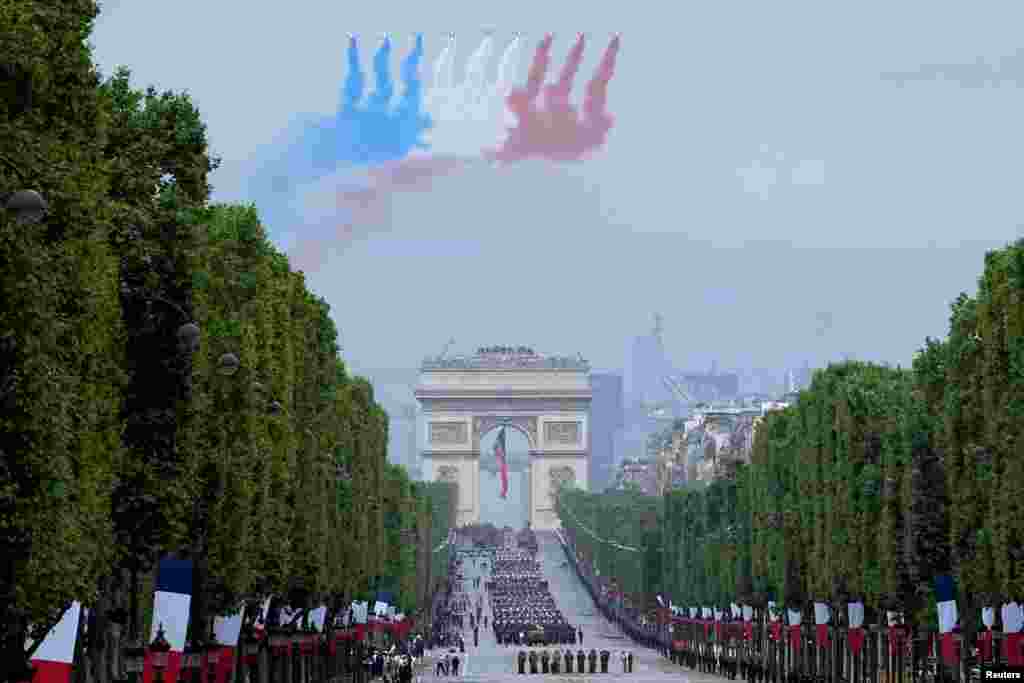 Jets of the Patrouille de France fly over the Champs-Elysees avenue during the Bastille Day parade in Paris.