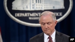 FILE - Attorney General Jeff Sessions pauses during a news conference at the Justice Department in Washington, March 2, 2017. 