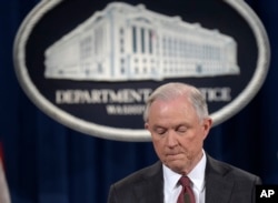 FILE - Attorney General Jeff Sessions pauses during a news conference at the Justice Department in Washington, March 2, 2017.