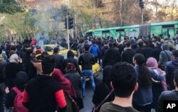 FILE - This photo taken by an individual not employed by the Associated Press and obtained by the AP outside Iran shows demonstrators attend a protest over Iran's weak economy, in Tehran, Iran, Dec. 30, 2017.
