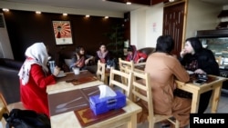 Afghan youths have coffee at a coffee shop in Kabul, Afghanistan June 22, 2018.