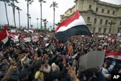 FILE - Protesters chant anti-government slogans during mass demonstrations against Egypt's President Hosni Mubarak, in Alexandria, Egypt, Feb. 4, 2011.