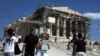 Athens Tourists Feel Potholes, Not Cash Worries