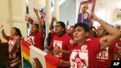 FILE - Demonstrators march in the Texas Capitol in Austin, protesting the state's new anti-sanctuary cities bill, May 29, 2017.