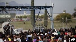 Relatives of inmates wait for news of their relatives outside the state prison in Apodoca, on the outskirts of Monterrey, February 19, 2012.
