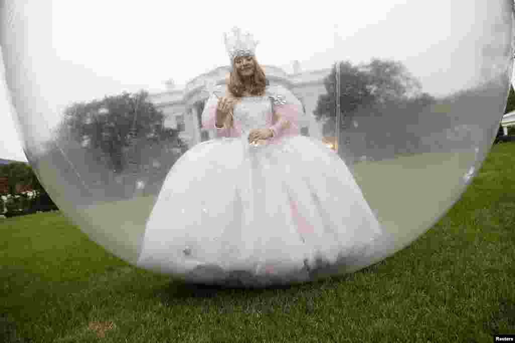 An actress in a "good witch" costume walks around ahead of a Halloween reception for children on the South Lawn at the White House in Washington, D.C., Oct. 31, 2013.
