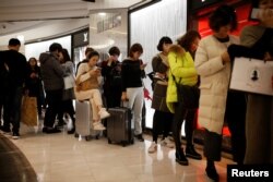 Chinese tourists wait in a line at a Lotte duty free shop in Seoul, South Korea, Dec. 13, 2016.